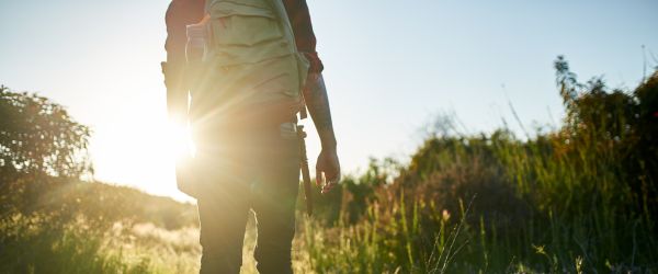 Man hiking through grass 