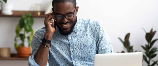 man in glasses on the phone