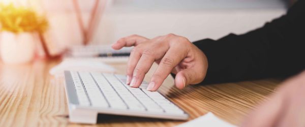 Person typing on keyboard