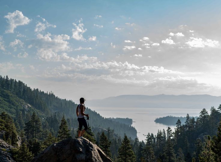 Woman hiking overlooking a lake