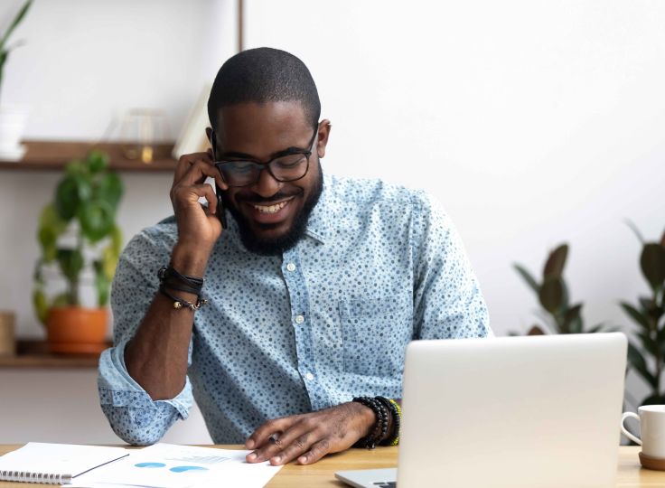 man in glasses on the phone