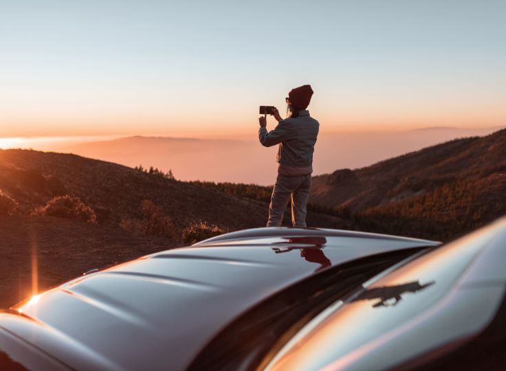 Person taking a photo of a sunset 