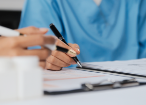 A clinician completes paperwork