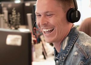 A FlexCare recruiter smiling while speaking to a clinician